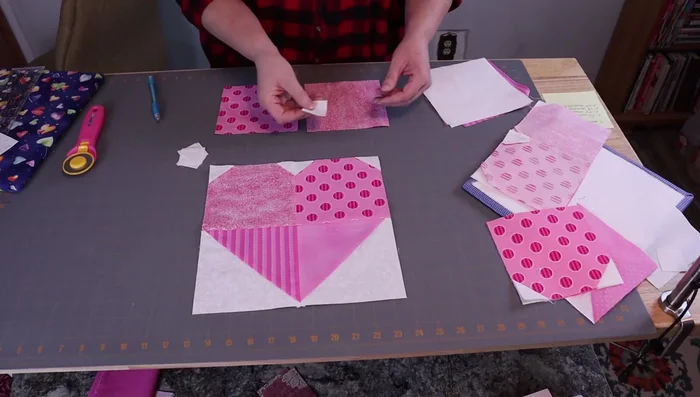 Create half-square triangles from 6.5-inch squares by drawing lines, sewing, trimming, and pressing.