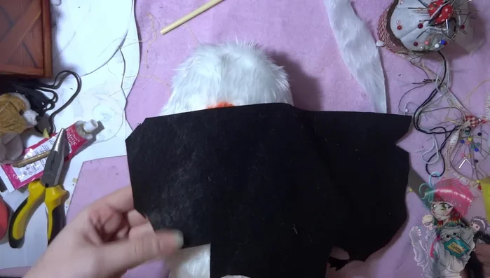 Add eyes. Glue on small black circles for eyes.