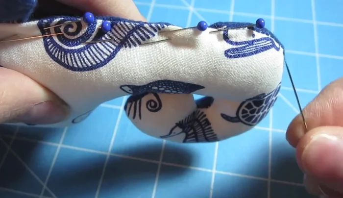 Hand-sew the opening closed using a needle and thread, ensuring the knot is on the inside. Sew along the 1/4 inch line.