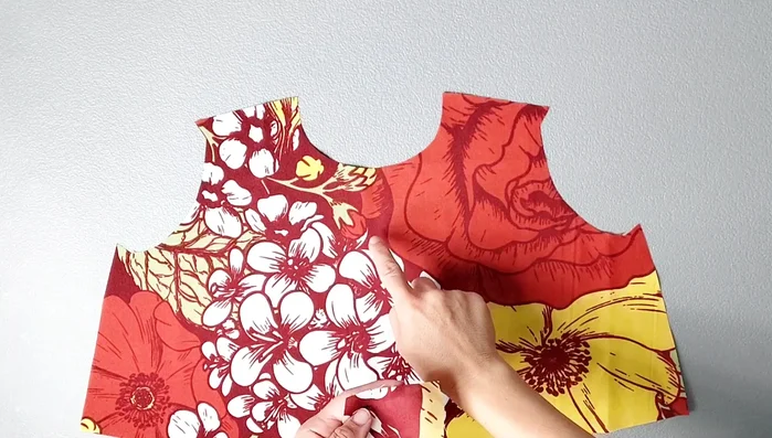 Attach shoulder panels to the front piece, matching notches. Sew, serge, and press seams open.