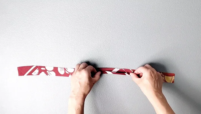 Prepare armhole binding: Fold long edges 3/8 inch, one short edge 5/8 inch. Repeat for both pieces.