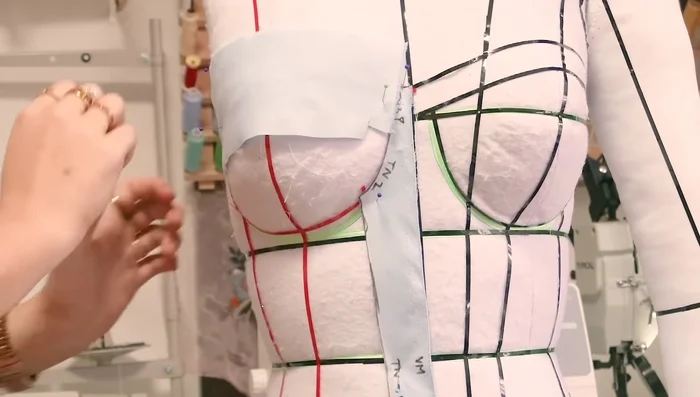 Drape the cup pieces (top, middle, bottom), ensuring smooth fabric and following apex lines. Note the slight angle for better draping on curves.