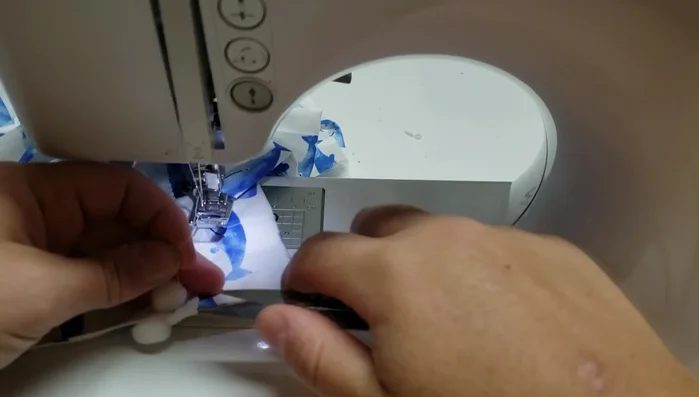 Create buttonholes (or grommets): Measure and place buttonholes approximately 6 inches apart and 1.5 inches in from the sides. Cut open the buttonholes.