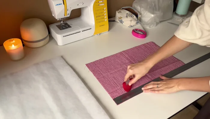 Quilt the fluffy material to the outer fabric square. Use vertical lines approximately 4cm apart. Pin the distances if your marker doesn't work on the fabric.