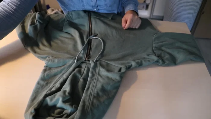 Use a safety pin and the old drawstring to pull the new one into place, adding nuts to the ends.