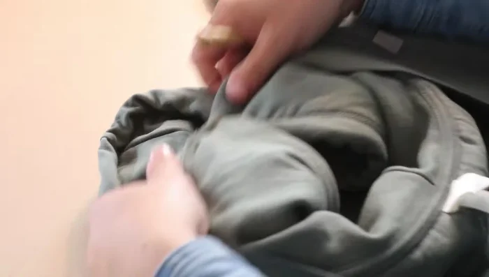 Use a seam ripper to undo the stitches holding the hood in place at the front.