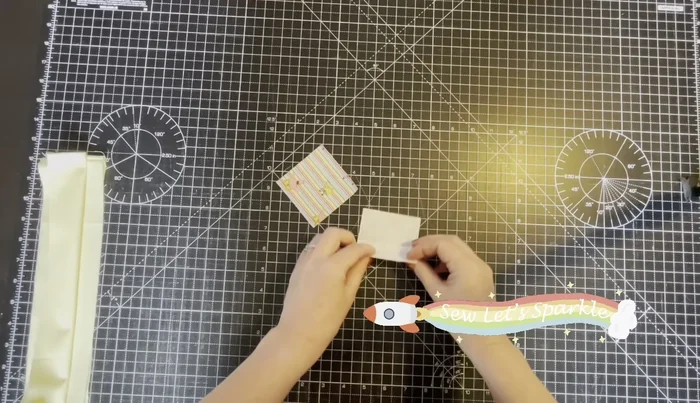 Make Tabs: Fold each 3-inch square in half, open, then fold in half again. Repeat for the other side. Fold over the top and sew close to the edge on both sides.