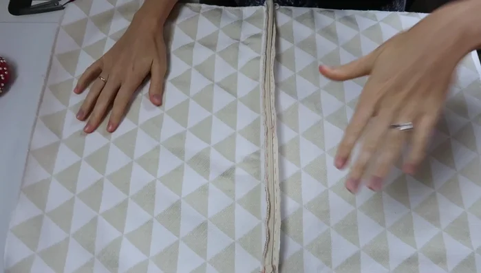 Sew the zipper: Remove the original basting stitches holding the seam closed. Zip the zipper all the way down. Using an invisible zipper foot or piping foot, sew right next to the zipper teeth on both sides. Pull the zipper back up and double-check.