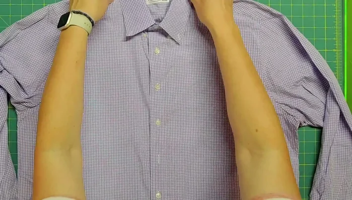 Iron the shirt and lay it flat on a surface, smoothing it out as much as possible. Trim off sleeves if necessary.