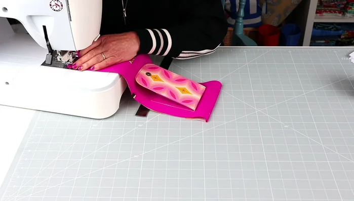 Employ the ingenious folding and stitching technique to create the firm back spine, adding strength and structure to the bag while forming a slip pocket.