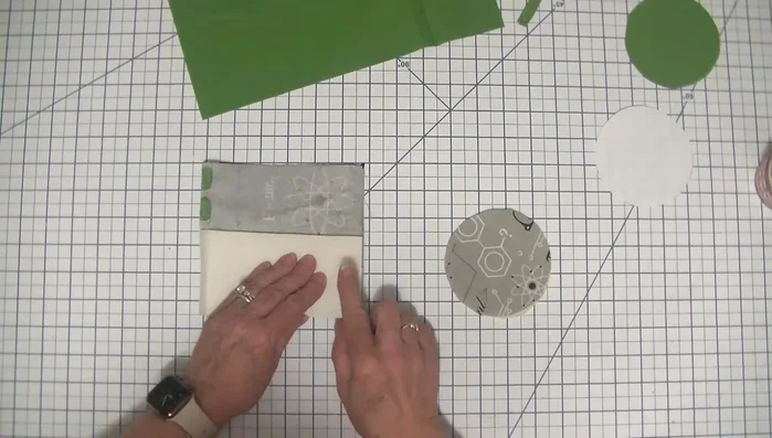 Attach the bottom piece (with fused foam) to the tube, right sides together. Pin or clip to secure. Stitch using a 1/4 inch seam allowance, remembering to leave a 1/2 inch gap for turning. (This gap should be 1 inch from the top).