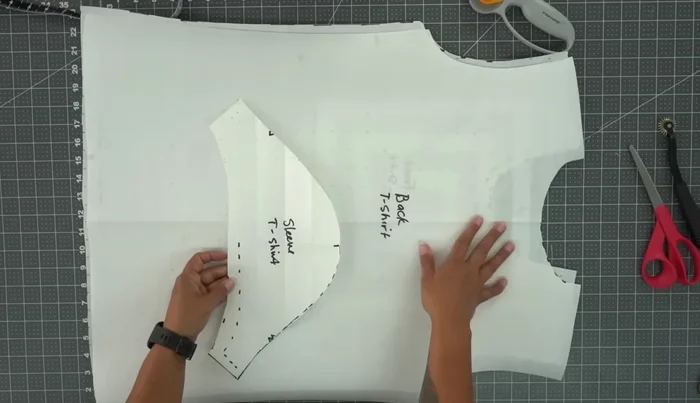 Cut out all pattern pieces: Cut out two sleeve pieces, one back piece, and one front piece.