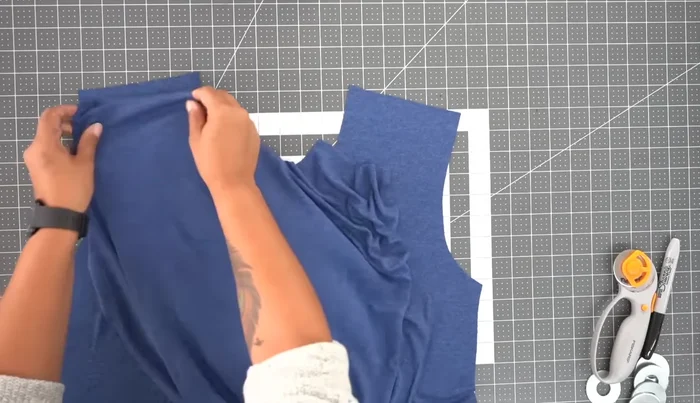 Sew the shoulders: Sew the front and back pieces together at the shoulder seams using 5/8 inch seam allowance. Serge or zig-zag stitch the seam allowance.