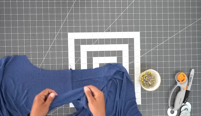 Attach the sleeves: Attach the sleeves using the flat method. Match the notches and ease in the sleeve cap. Stitch using a 1/2 inch seam allowance. Repeat for the other sleeve.