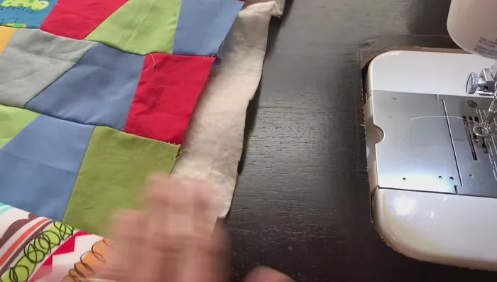 Quilt the layers: Use a darning foot and lower the feed dogs on your sewing machine. Free-motion quilt in a pattern of your choice (e.g., loops, waves). Ensure even tension and check for puckers as you go.