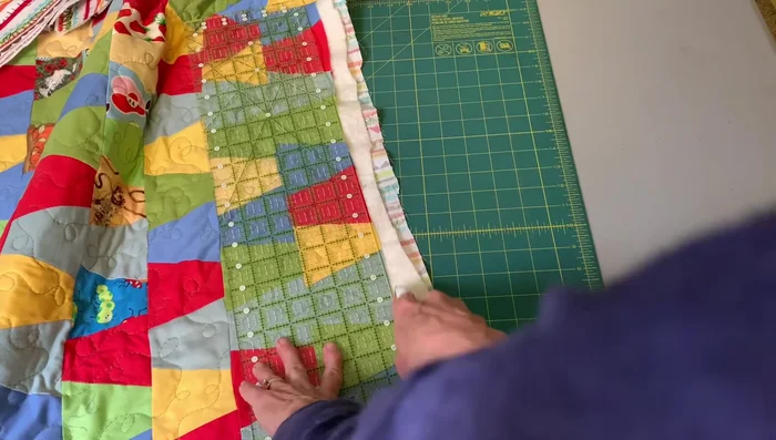 Trim the quilt: Once quilted, trim the edges of the quilt, following the quilt top's edge.