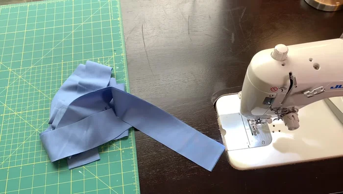 Prepare the binding: Cut 2.5-inch wide strips of fabric for the binding. Sew the strips together end-to-end to create one long strip. Press the seams open.
