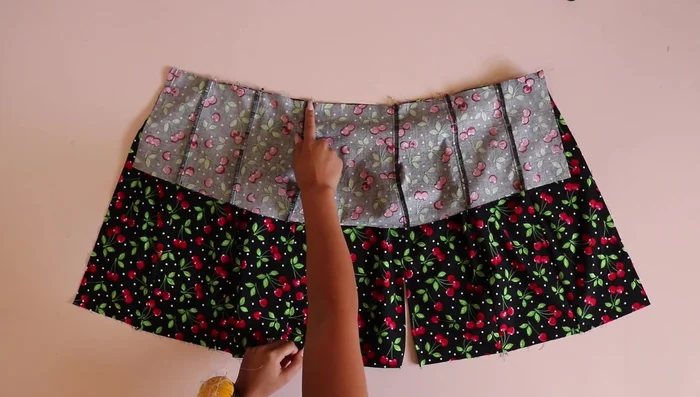 Sew the bodice and skirt together along the waistline seam, matching vertical seam lines. Finish and press.