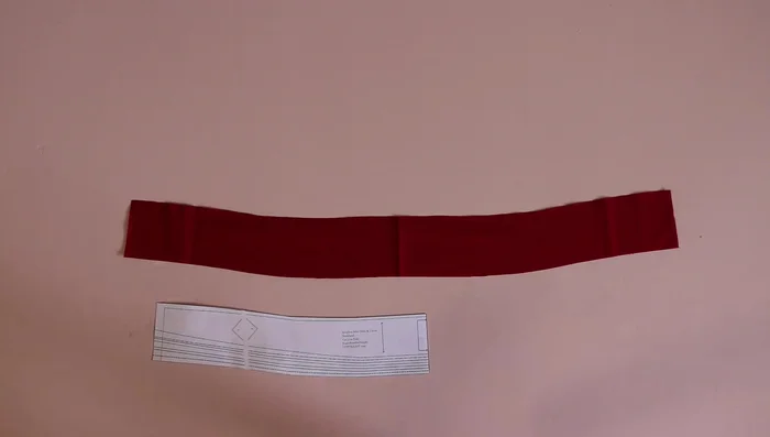 Attach neckline band to dress neckline, leaving about a quarter inch from the center back. Pin. Attach the facing, right sides together, and sew.