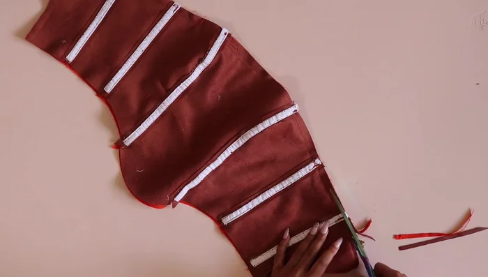 Fuse interfacing to center back of corset shell and lining. Turn right side out and top stitch.