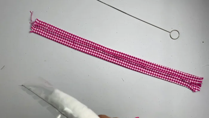 Once the fabric is fully covering the headband, remove the plastic tube (if used).