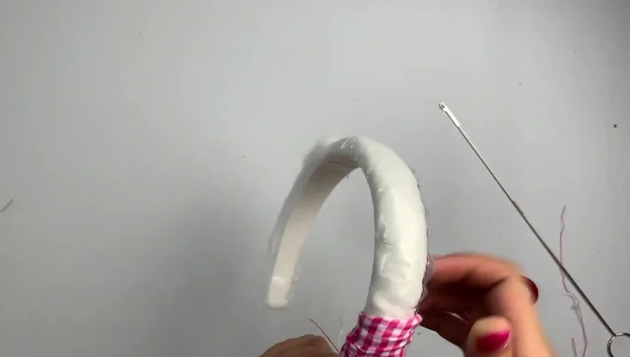 Once the fabric is fully covering the headband, remove the plastic tube (if used).