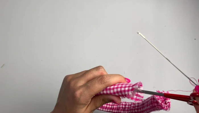 Once the fabric is fully covering the headband, remove the plastic tube (if used).