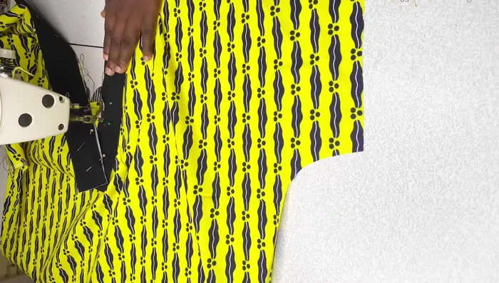 Sew the black fabric pieces to the blouse.