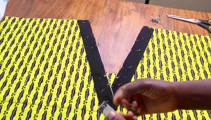 Sew the black fabric pieces to the blouse.