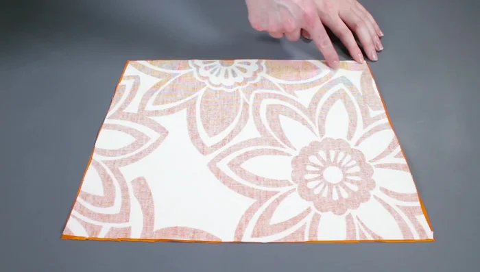 Fuse stabilizer to pockets: Place stabilizer between fabric pieces, centering and aligning with top edges. Iron on high heat for 5 seconds per area on both sides to fuse.