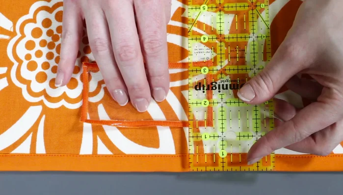 Attach label pockets to organizer: Position label pocket 1 1/2in from top of a pocket and sew around sides and bottom.