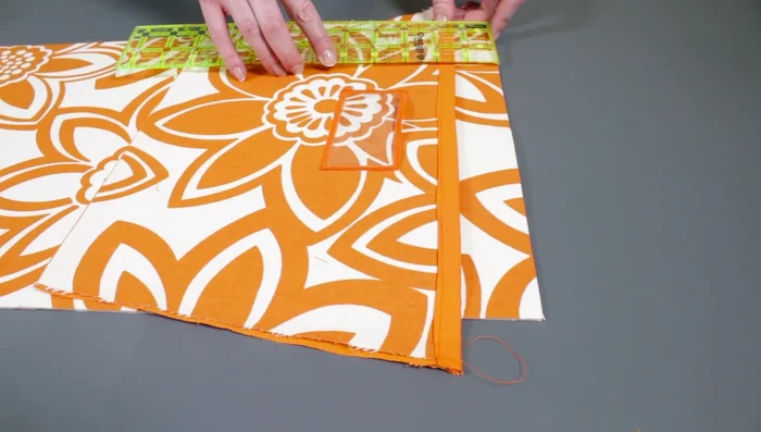 Attach pockets to backing: Place pockets 1 1/2in from the top of the backing, overlapping. Sew along the bottom.