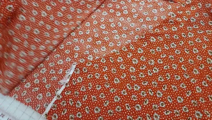 Attach ties to the bodice, sandwiching them between the facing and bodice. Sew and trim seam allowances.