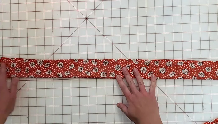 Attach ties to the bodice, sandwiching them between the facing and bodice. Sew and trim seam allowances.