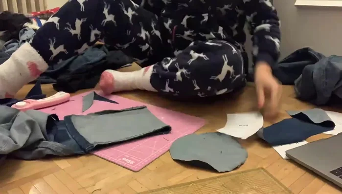 Cut fabric: Using a pattern (linked in the video description), cut out the necessary pieces for the crown and brim of the hat. Note the seam allowance instructions on the pattern and cut accordingly for both the inside (single denim color) and outside (alternating denim colors) of the hat.