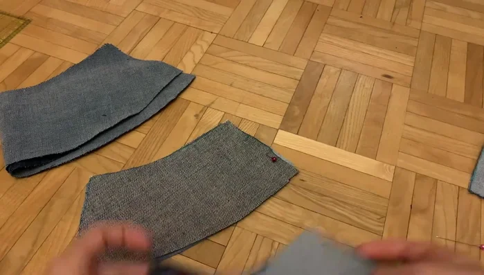 Sew crown pieces: Sew the crown pieces together, alternating the denim colors as desired, using a 1/4 inch seam allowance. The video demonstrates a technique to alternate colors using a modified cut that avoids cutting on the fold.