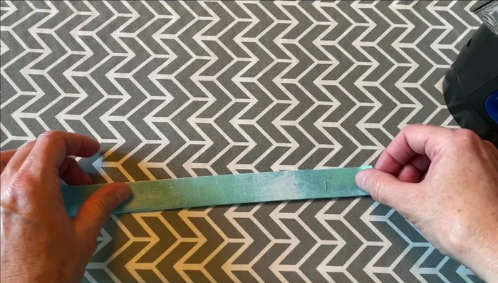 Bind: Cut 2-inch binding strips, fold in half, and iron. Attach binding to the back, wrap to the front, and stitch down.