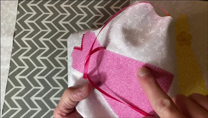 Sew Dresses to Background Fabric: Stitch around the edge of each dress to secure it to the background fabric.