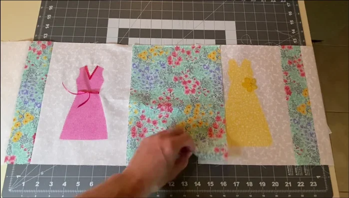 Attach Center Fabric: Sew the center fabric rectangle to the left and right dress blocks, creating the main table runner panel.