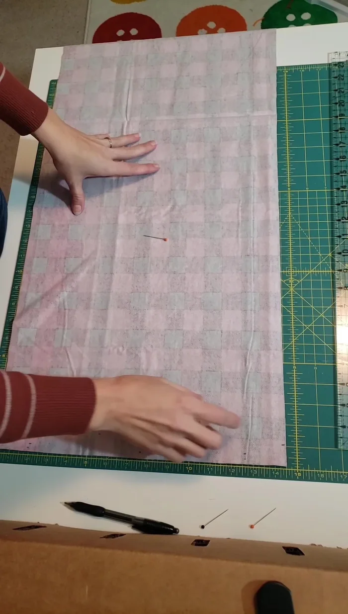 Fold the flannel fabric in half lengthwise (hot dog style), matching the raw edges. Pin to hold.
