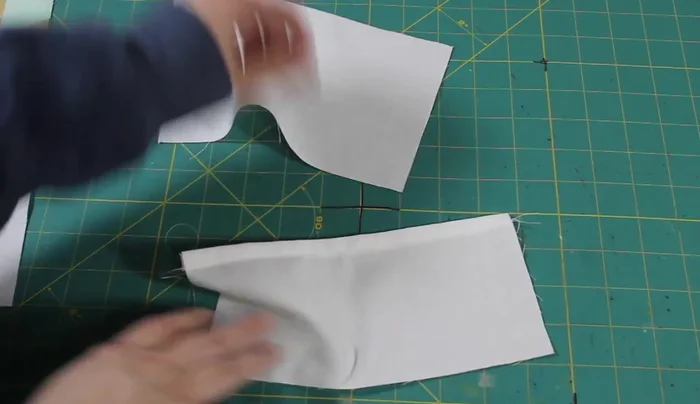 Prepare the pocket piece: Cut a smaller rectangle for the inner pocket, hem the top edge, and sew a line down the middle to create two pockets.