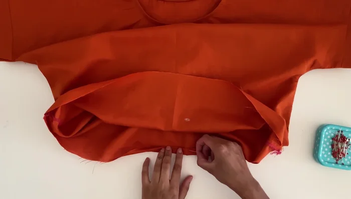 Hem the bottom: Fold the bottom edge twice by 3/8 inch or 1 cm, pin, and sew close to the edge for a neat finish.