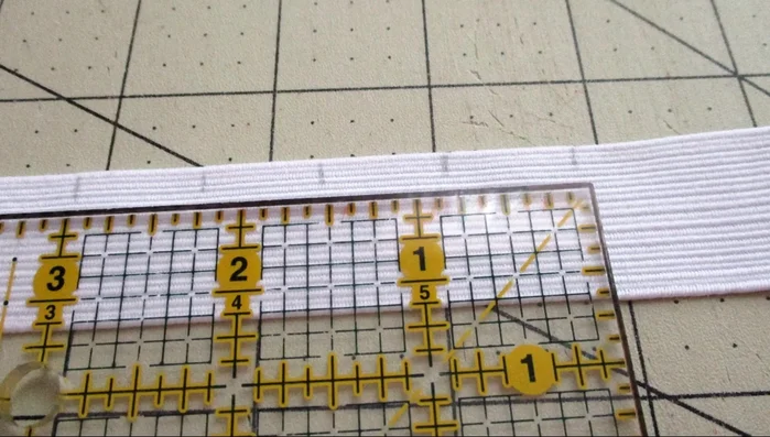 Match up elastic and fabric markings, stitching the elastic to the fabric at each marked point. Back tack at the beginning and end of each stitch.