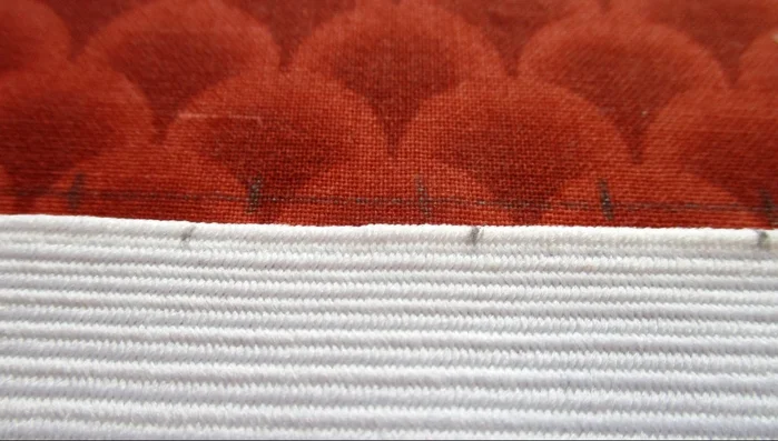 Match up elastic and fabric markings, stitching the elastic to the fabric at each marked point. Back tack at the beginning and end of each stitch.