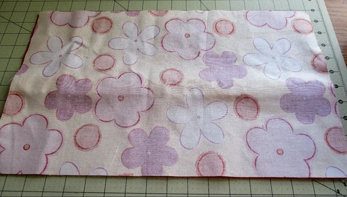 Stitch all around with a 1/2 inch seam allowance, leaving a space at the bottom for turning. When stitching near the elastic loops, pull the main fabric over to match edges before stitching.