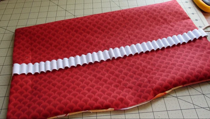 Clip corners, turn right side out, fold bottom edges under 1/2 inch, press, and topstitch around the entire piece, closing the bottom opening.