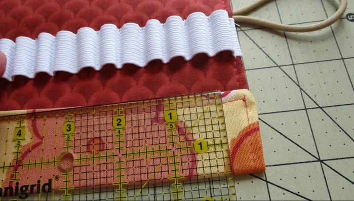 Fold the bottom of the fabric up 1 1/2 inches (or 2 inches), pin, and stitch to create a pocket. Repeat on the other side. Stitch down the middle of the pocket to close the gap.