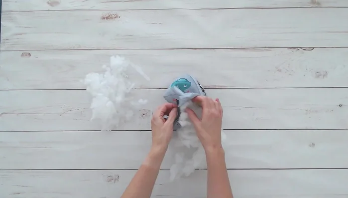 Lightly stuff the cube with polyfill to maintain its shape and make it easy for a baby to grip. Avoid overstuffing.