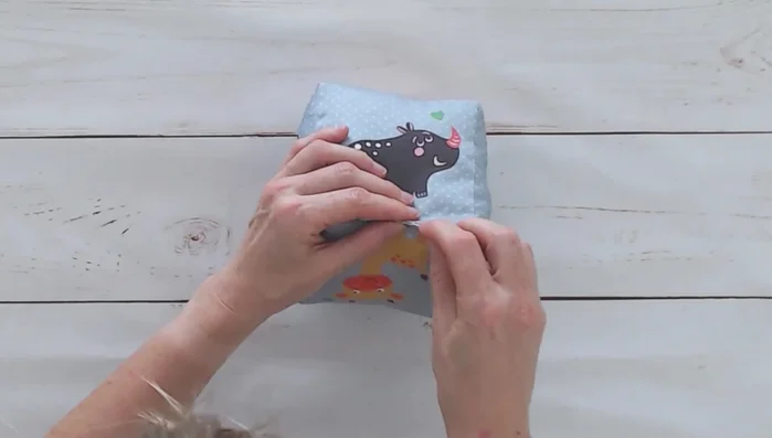 Hand-sew the gap closed using a ladder stitch, overlapping the machine stitching by a quarter inch.