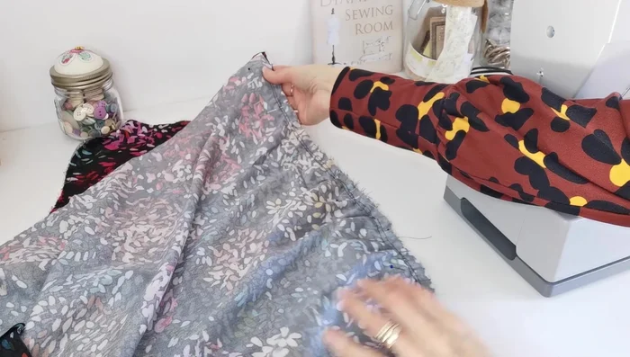 Attach Sleeves: Pin and sew sleeves to armholes, matching notches and center points, pulling gathering stitches to even the fabric.